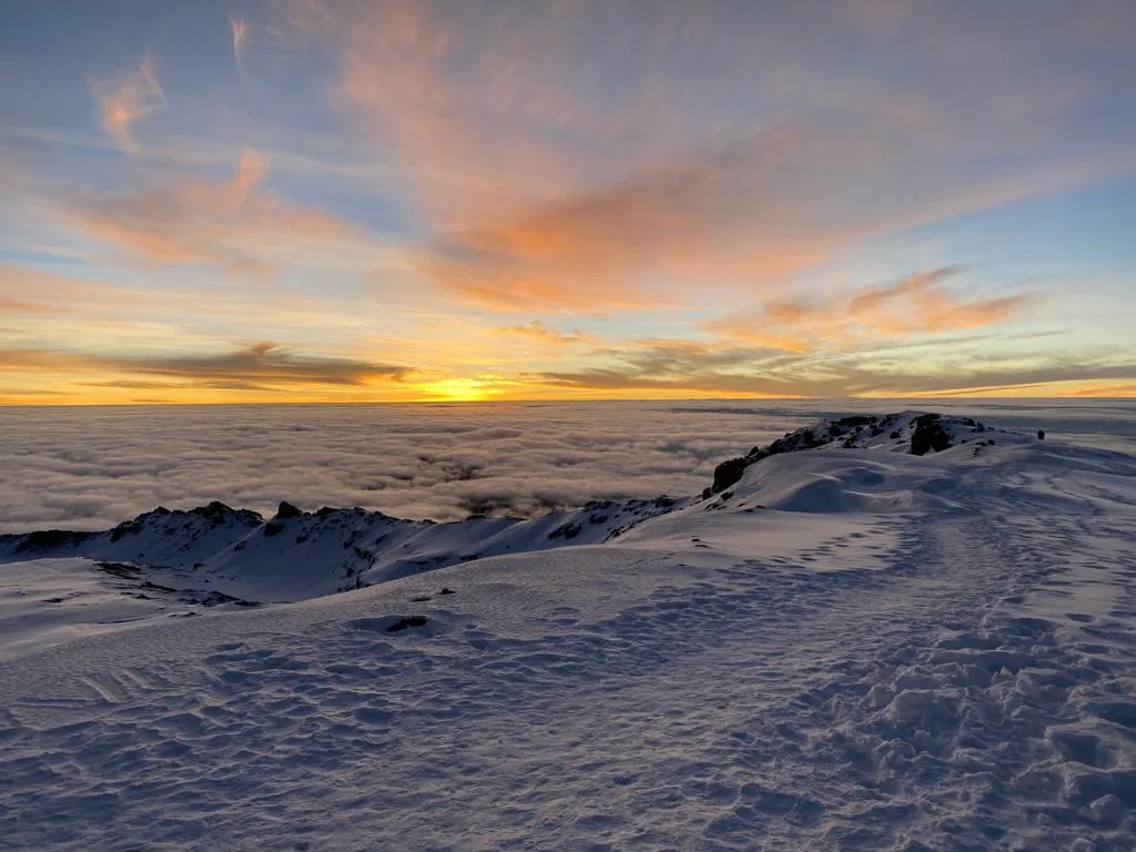 Climbers celebrating at Uhuru Peak summit on Mount Kilimanjaro