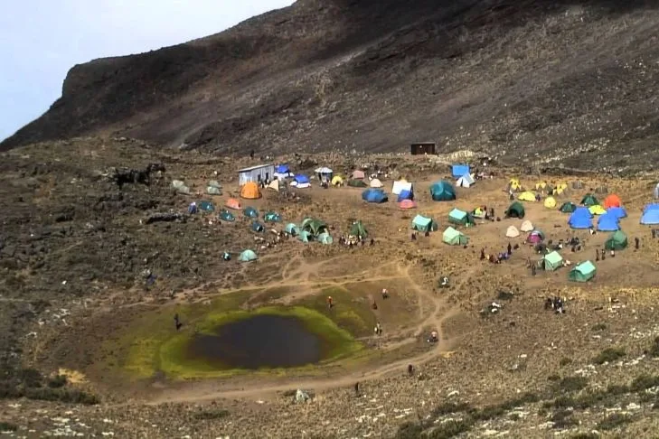 Climbers celebrating at Uhuru Peak summit on Mount Kilimanjaro